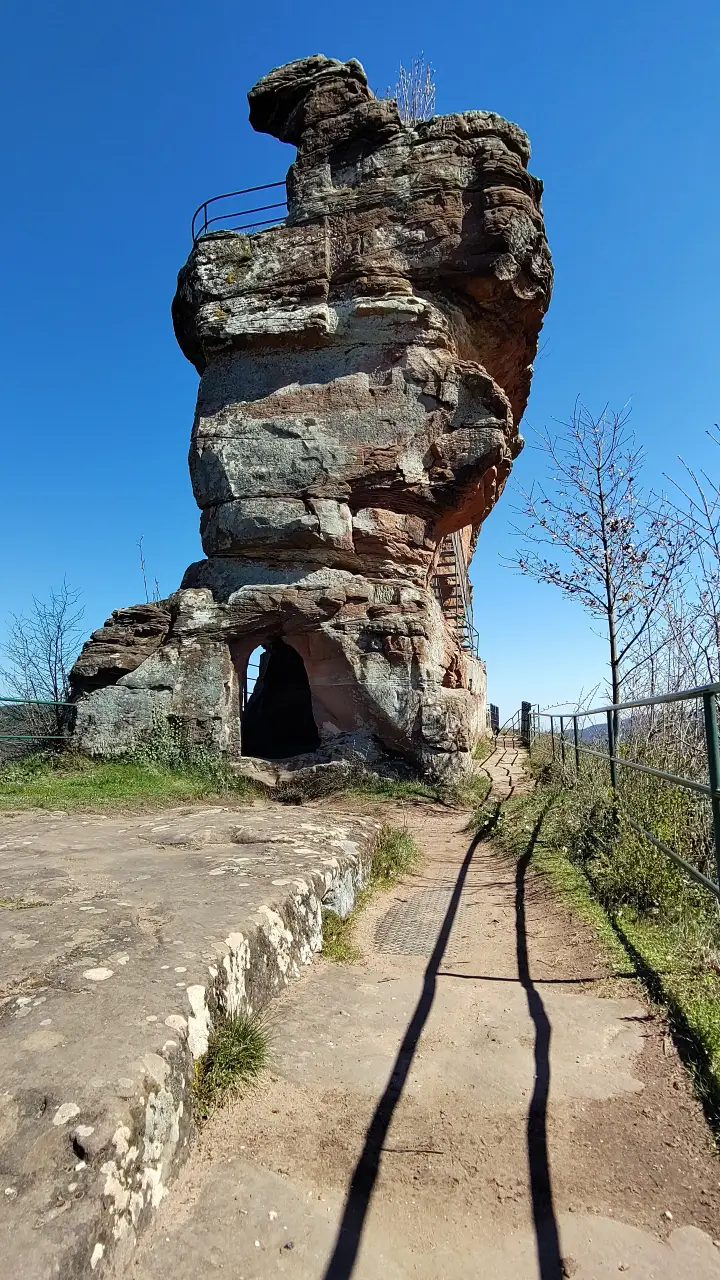 A tall rock needle with a few windows and passageways
