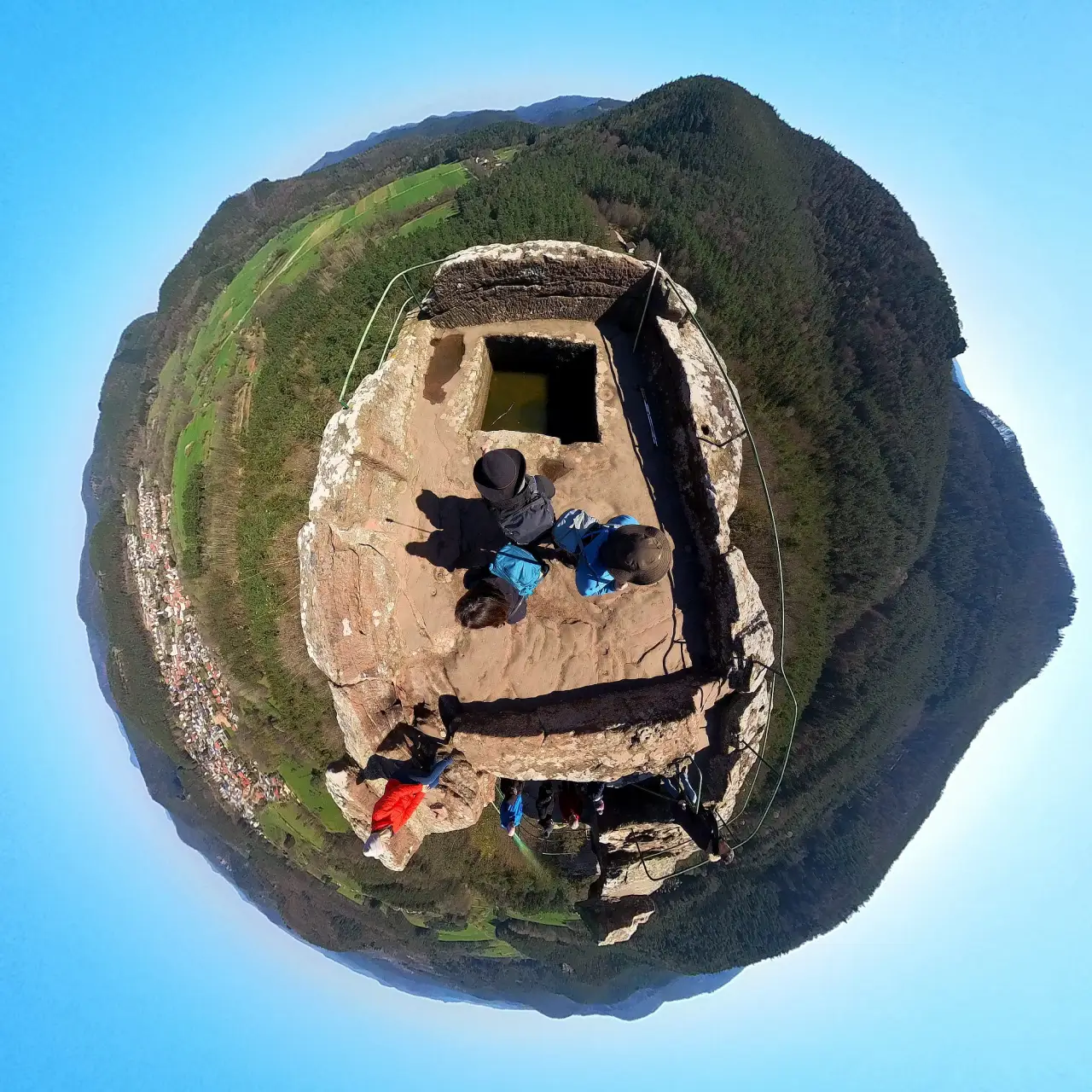 360° tiny planet panorama of the top of the rock needle. You can see far into the distance all around with views of Busenberg and the hills of the Palatinate Forest.
